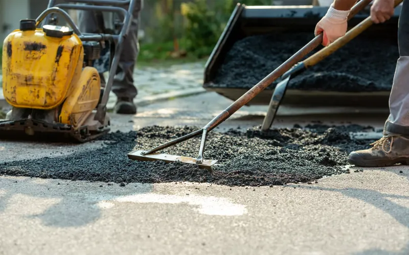 Men working on asphalt 